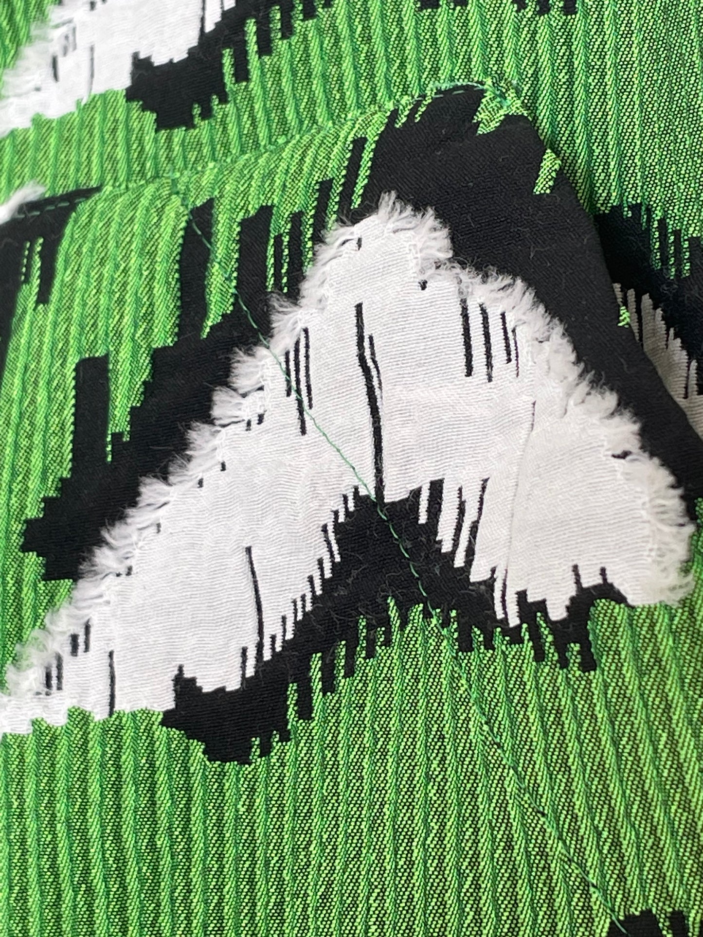 Jean-Paul Lespagnard pleated green, black and white jacquard trousers with "traces of wheels" pattern