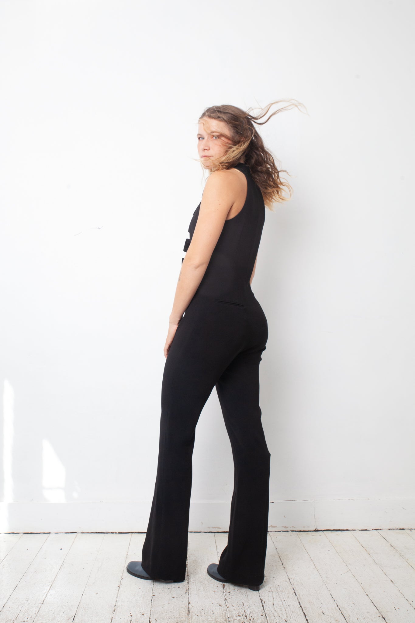 Ter & Bantine 2000's black flared jumpsuit with row of bows