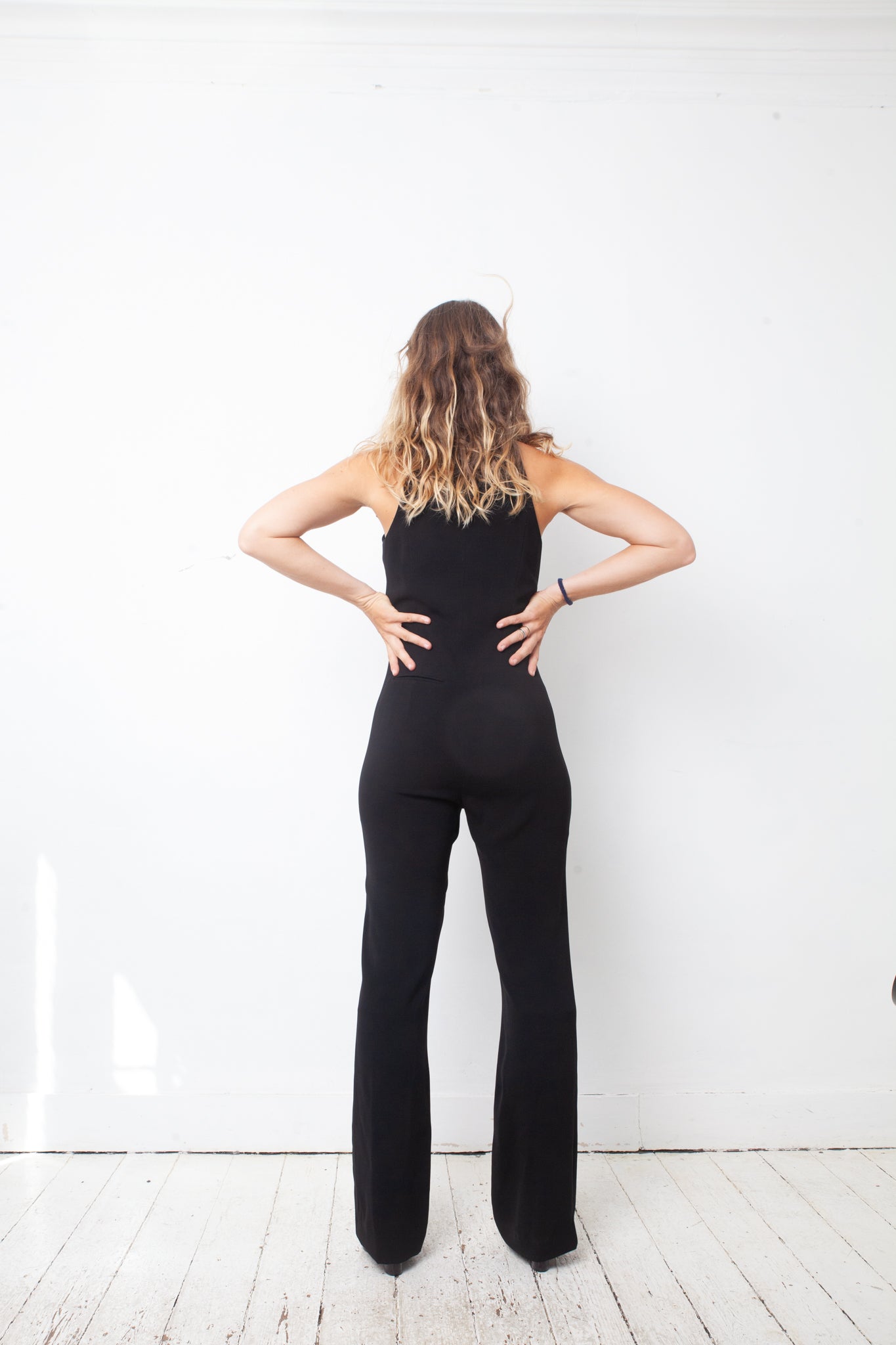 Ter & Bantine 2000's black flared jumpsuit with row of bows