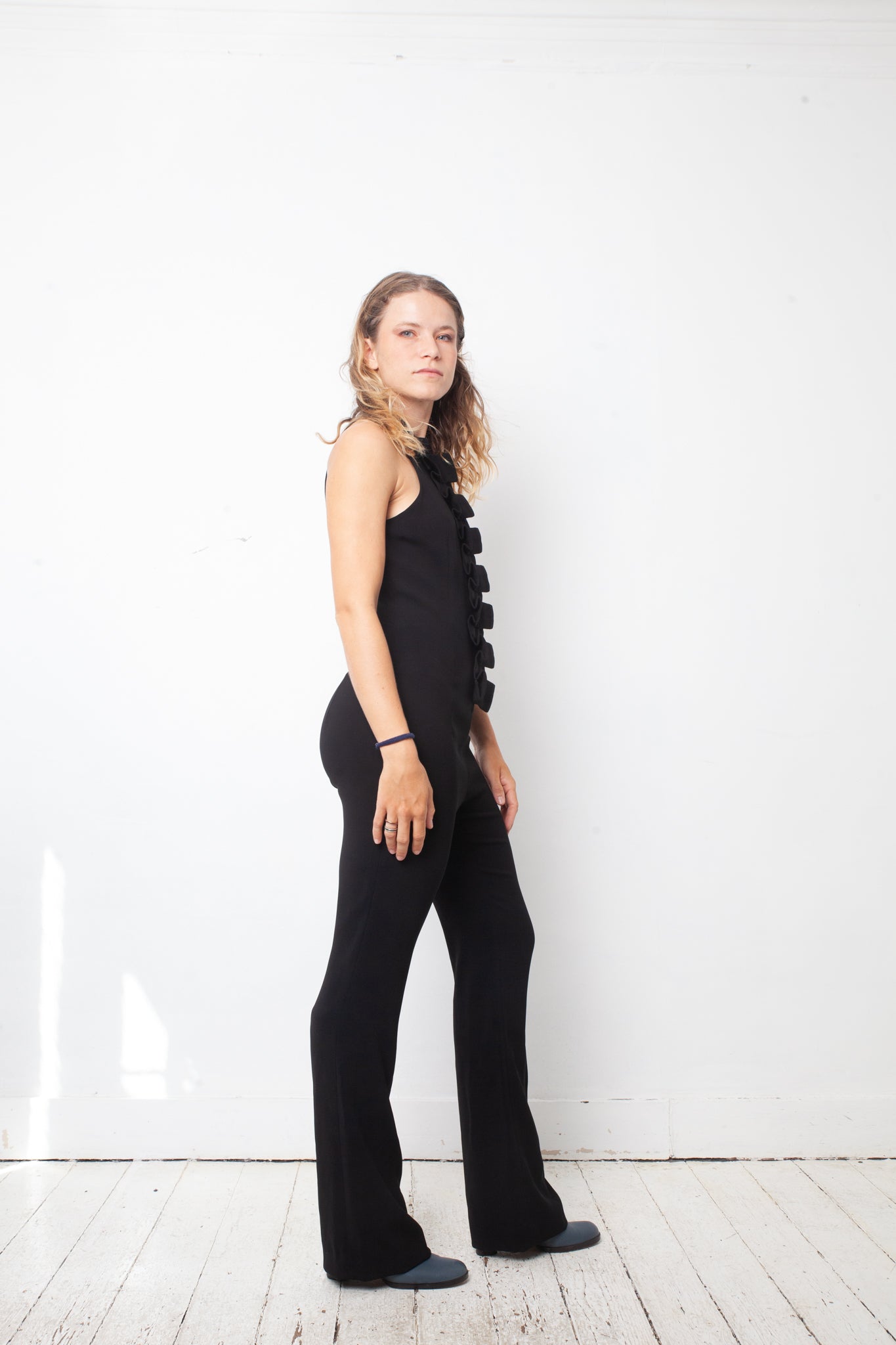 Ter & Bantine 2000's black flared jumpsuit with row of bows