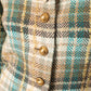 Chanel Haute Couture 1970s green tweed skirt suit with golden turtle buttons.