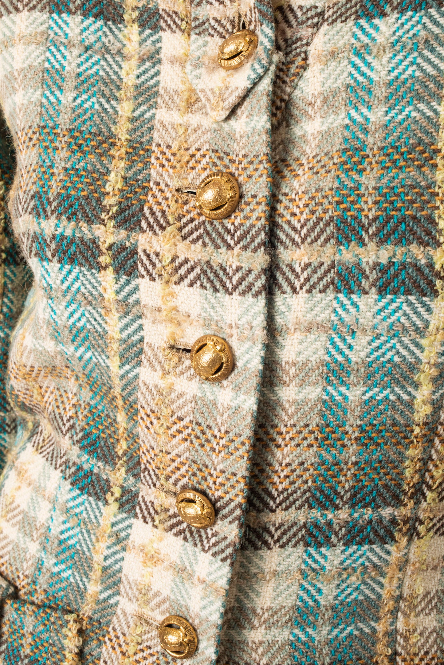 Chanel Haute Couture 1970s green tweed skirt suit with golden turtle buttons.