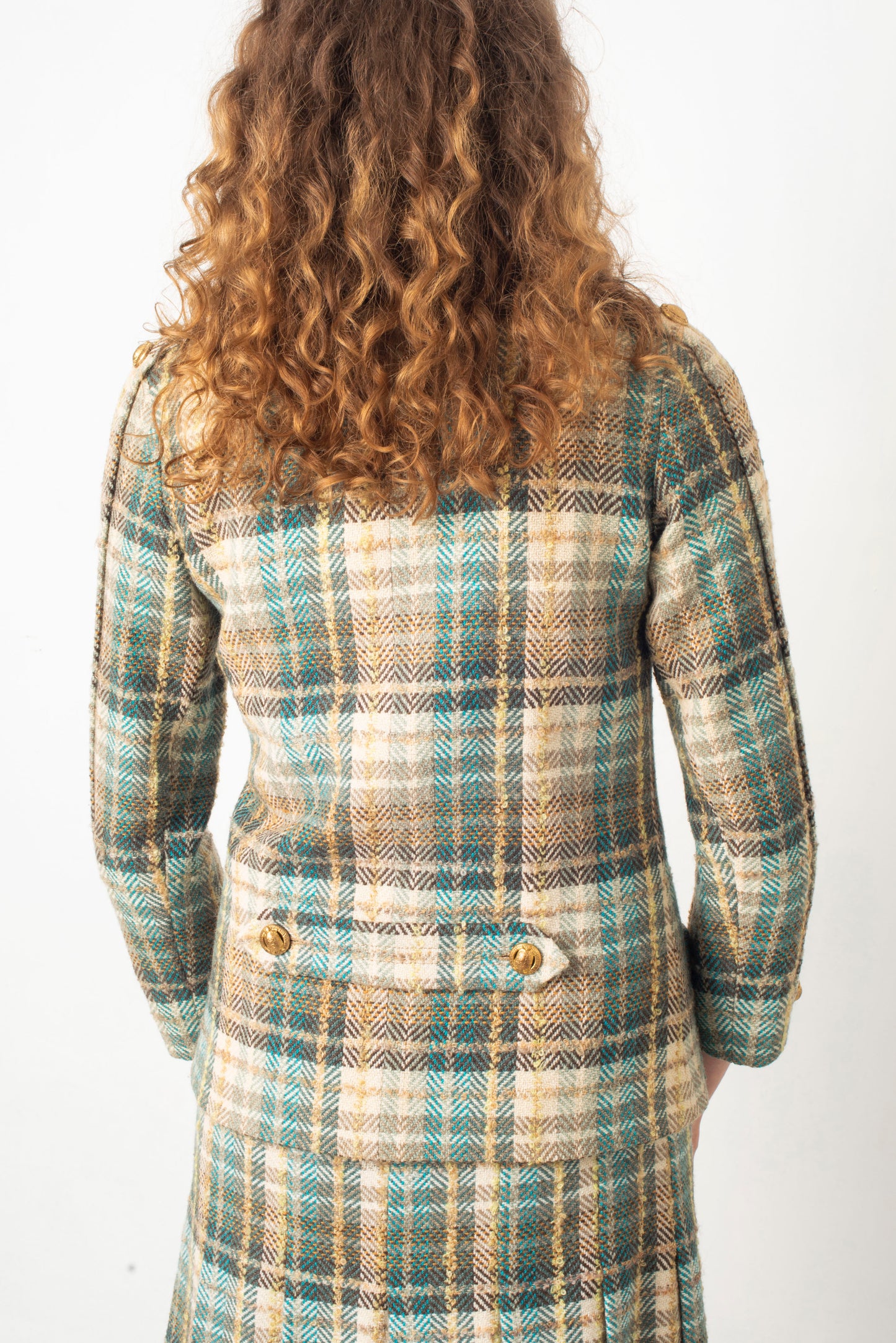 Chanel Haute Couture 1970s green tweed skirt suit with golden turtle buttons.