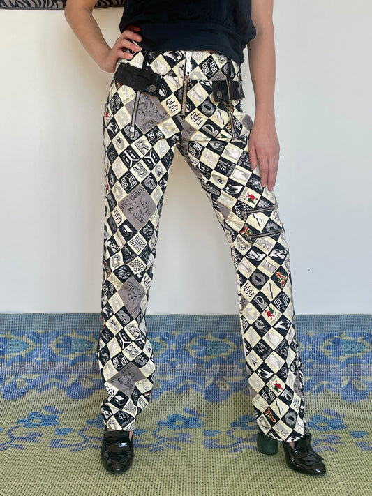Early 2000's Cappopera checkered pants with a crazy fonts and symbol print