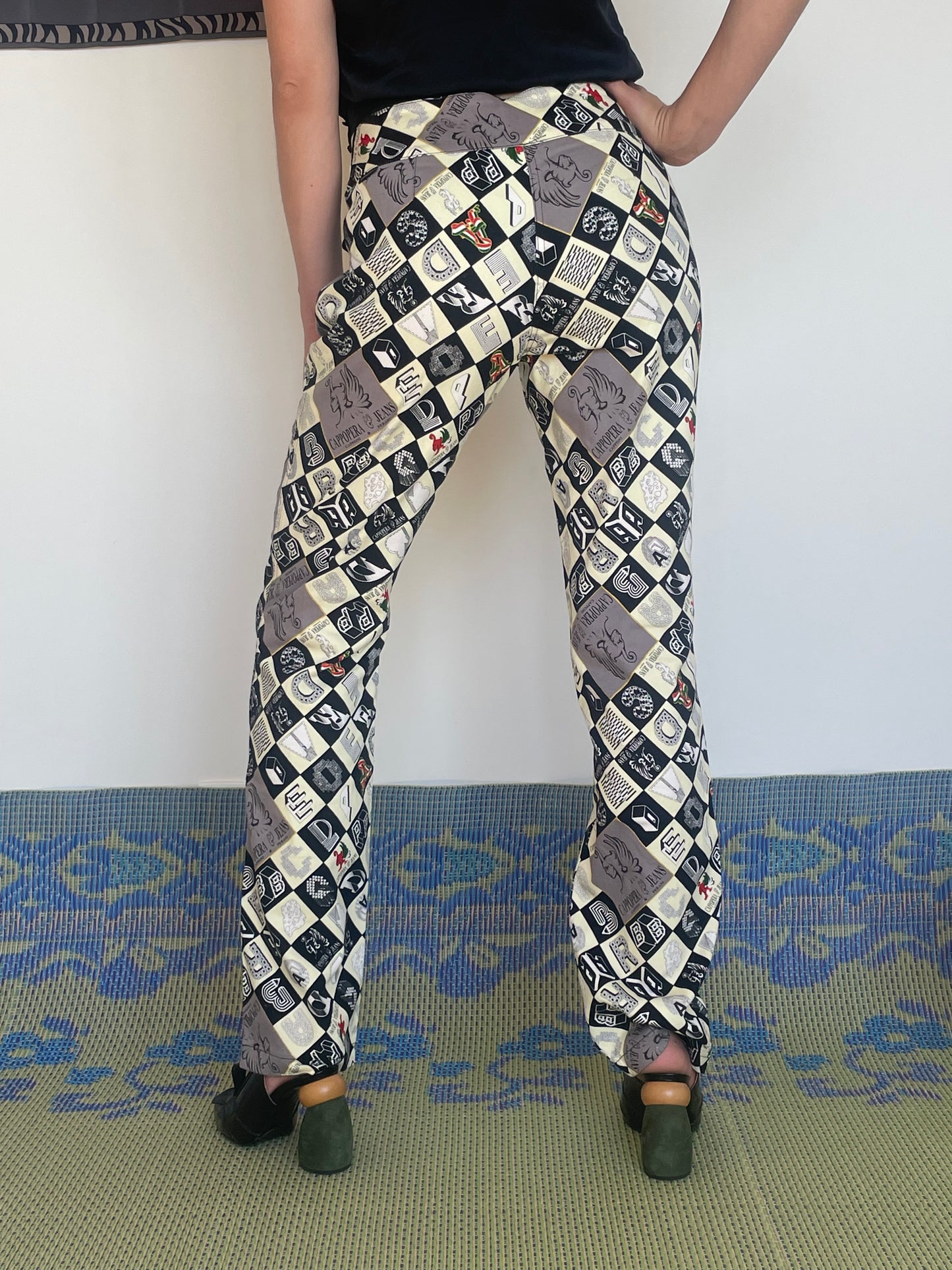 Early 2000's Cappopera checkered pants with a crazy fonts and symbol print