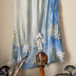 Voyage 2000's silk blue and white tie dye skirt with floral embroideries, mesh and lace patchwork