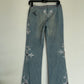 Voyage washed denim low waist trousers with tribal shaped gemstones