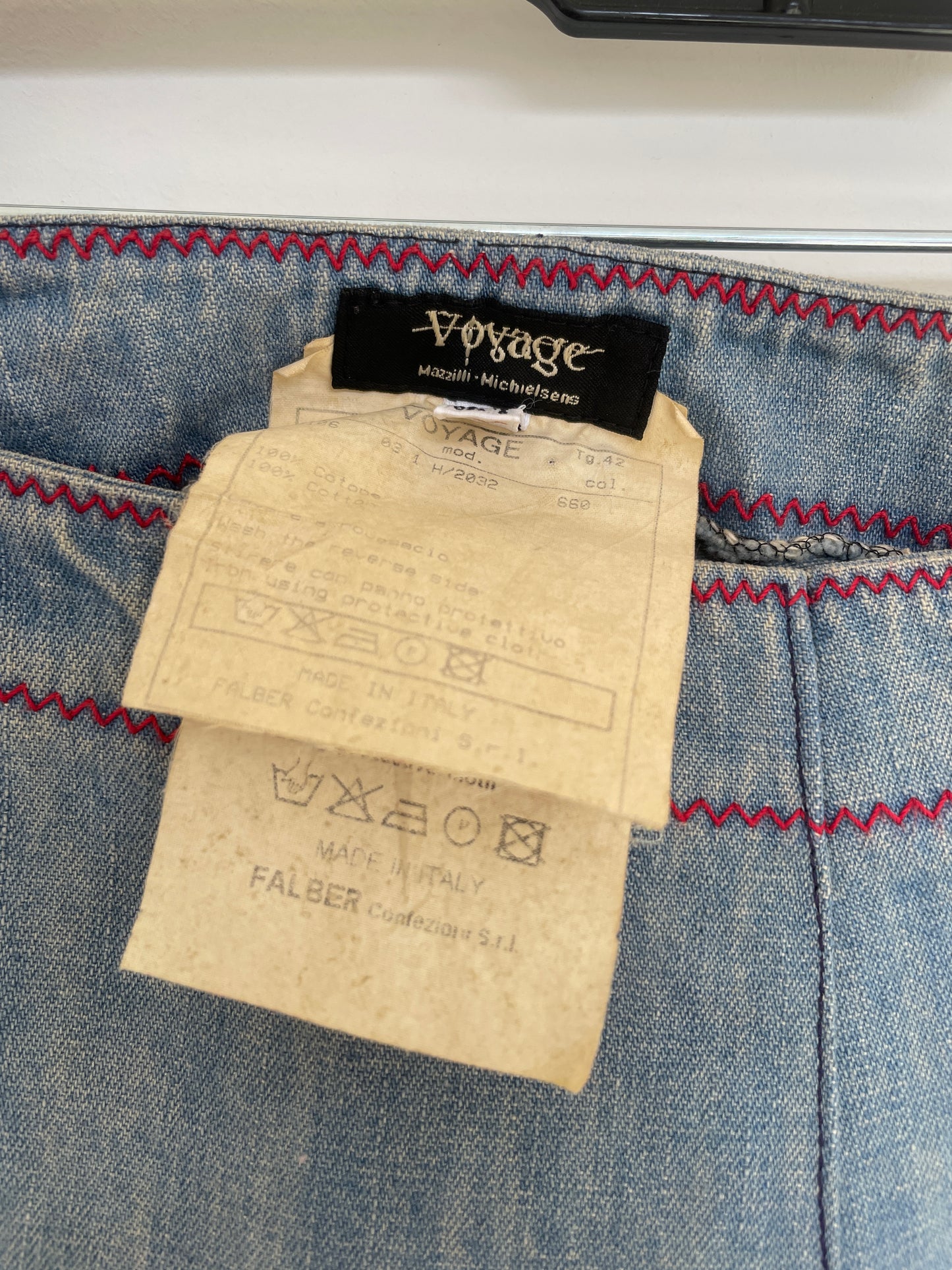 Voyage washed denim low waist trousers with tribal shaped gemstones